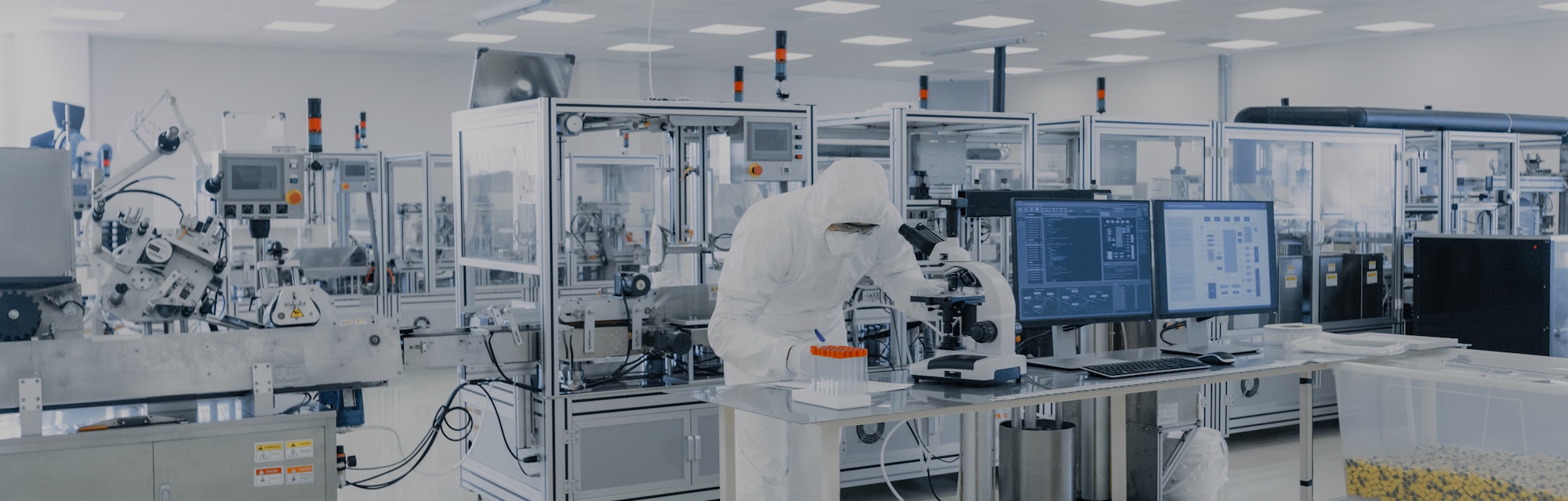 Shot of Sterile Pharmaceutical Manufacturing Laboratory where Scientists in Protective Coverall's Do...