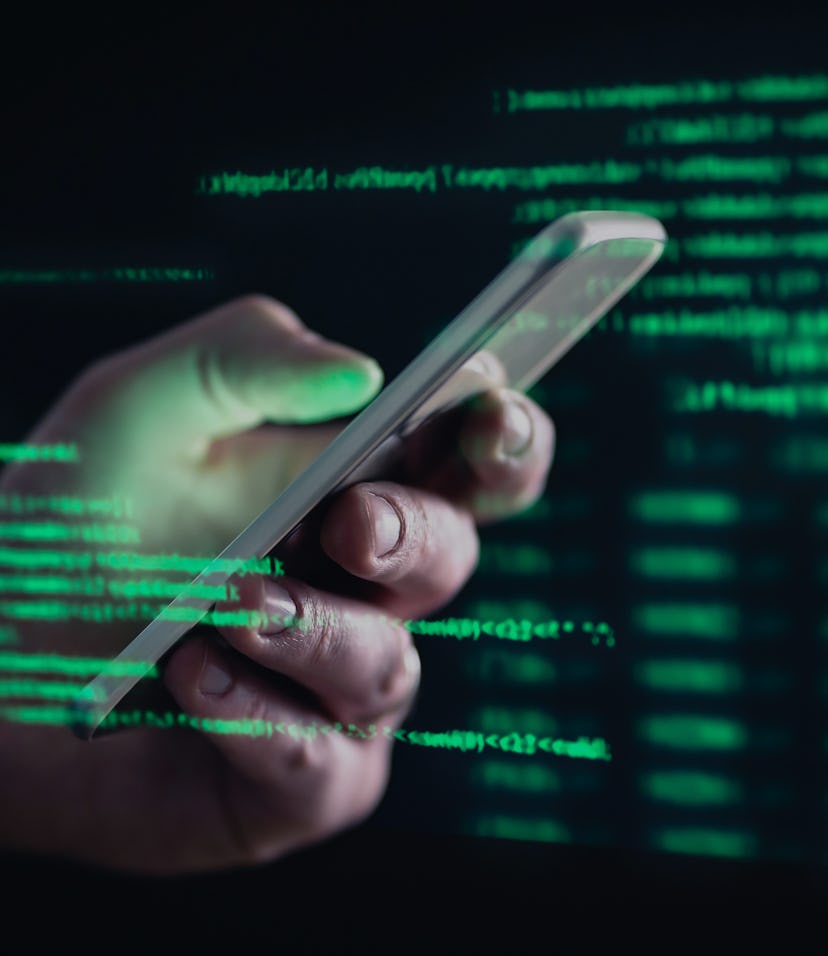 Darkweb, darknet and hacking concept. Hacker with cellphone. Man using dark web with smartphone. Mob...