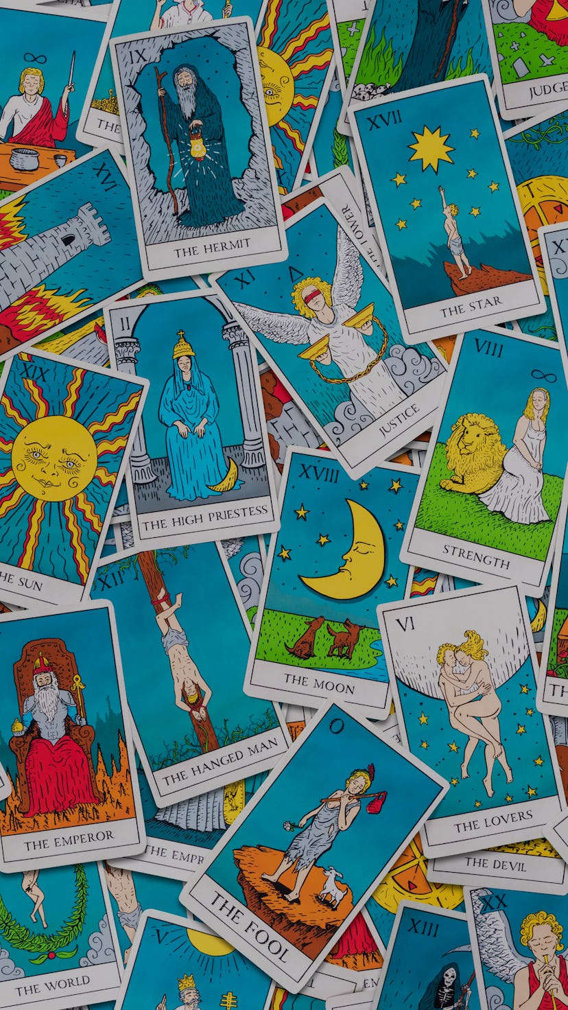 Assorted tarot cards scattered on a table, seamless pattern