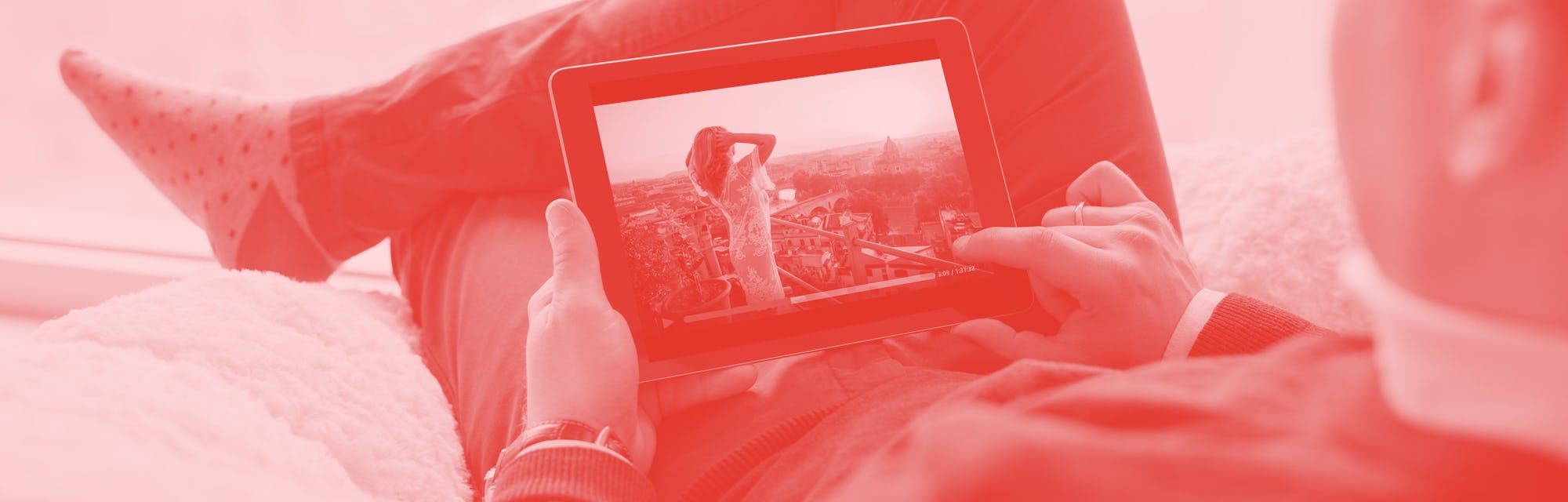 Man watching movie on tablet at home.