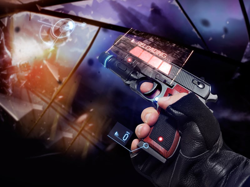 Hand in gloves holding a reloading handgun. First person view hand in black leather gloves holding a...