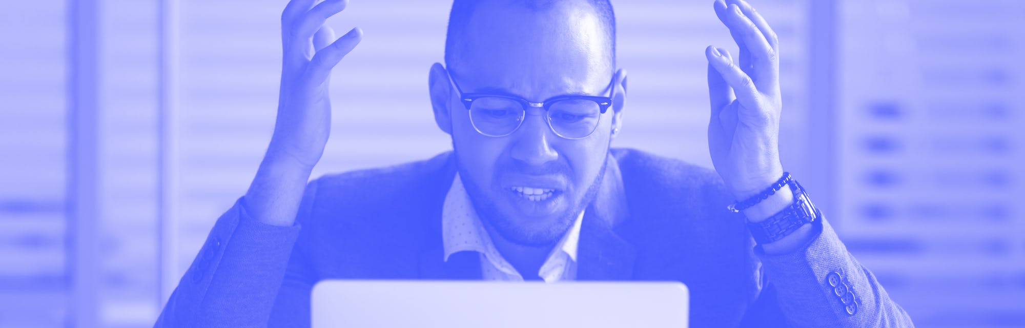 Angry stressed african business man using laptop mad about broken computer online problem annoyed wi...