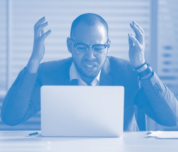 Angry stressed african business man using laptop mad about broken computer online problem annoyed wi...