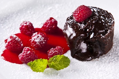 Delicious chocolate dessert with fresh raspberries and syrup
