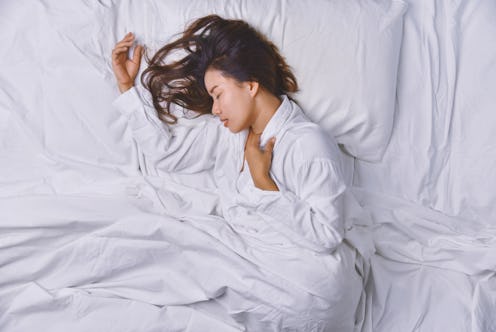 Young Woman Sleeping In Bed. Top view of young woman lying down sleeping well in bed. sleeping relax...