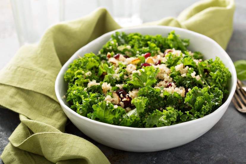 Fresh healthy salad with kale, almond, cranberry and quinoa