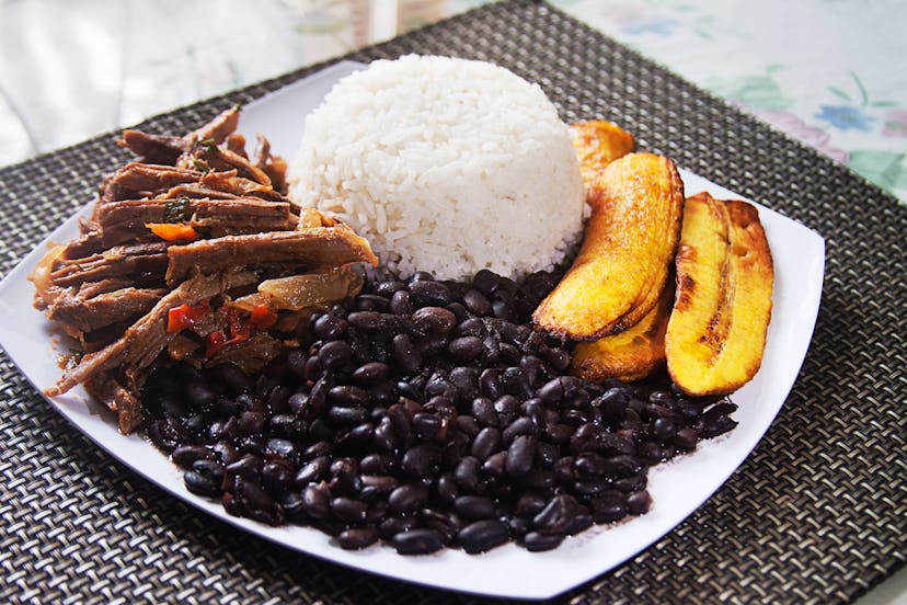 Homemade Venezuelan food. Traditional Venezuelan dish. Pabellon Criollo. White Rice, Black beans,Fri...