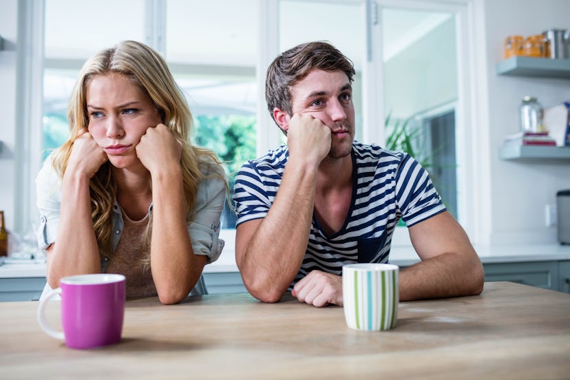 Close up of annoyed couple ignoring each other in the kitchen