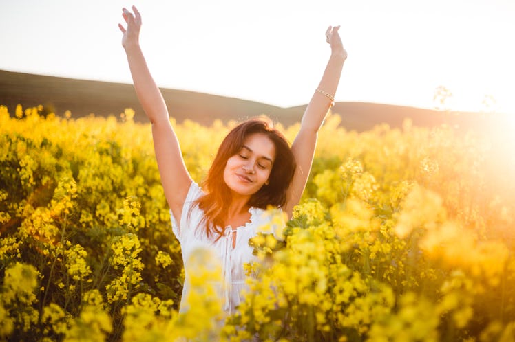 Teenage girl in yellow flowers field