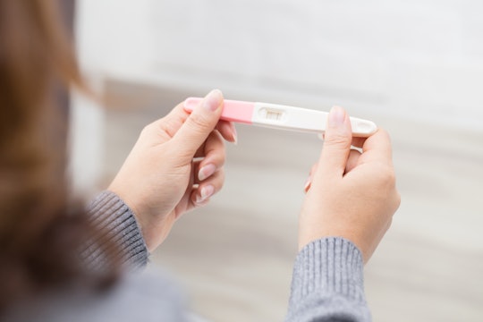 Here's how spotting can affect the results of your pregnancy test, according to experts.