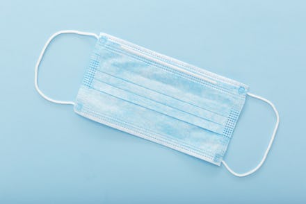 Medical mask, Medical protective mask on blue background. Disposable surgical face mask cover the mo...