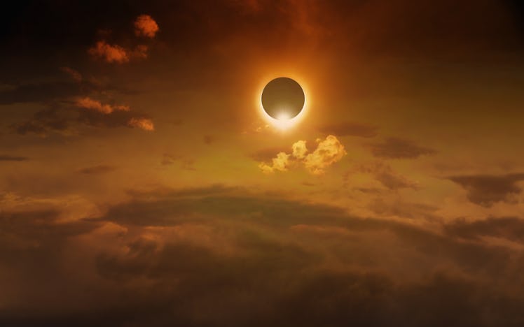 Amazing scientific background - total solar eclipse in dark red glowing sky, mysterious natural phen...