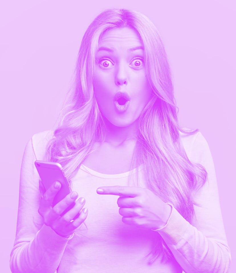 Blonde young female with pleasant appearance looks with terrified expression in smart phone, reads s...