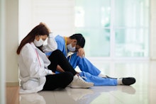 Exhausted tired Asian doctor or nurse. Virus outbreak in Asia. Coronavirus pandemic. Clinic and hosp...