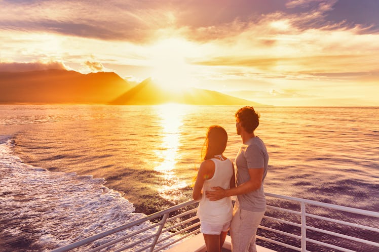 Travel cruise ship couple on sunset cruise in Hawaii holiday. Two tourists lovers on honeymoon trave...
