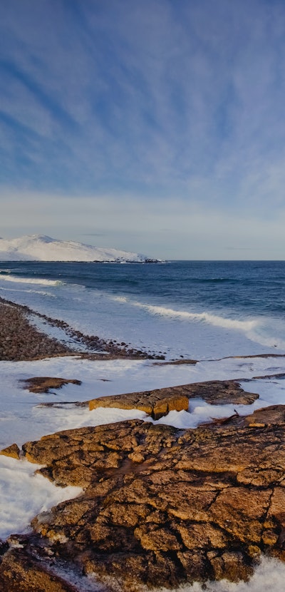 Winter storm in a sunny day in the Arctic Ocean, the Barents Sea, the settlement of Teriberka, Russi...