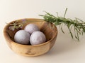 Lavender bath bombs in a wooden bowl with lavender cuttings