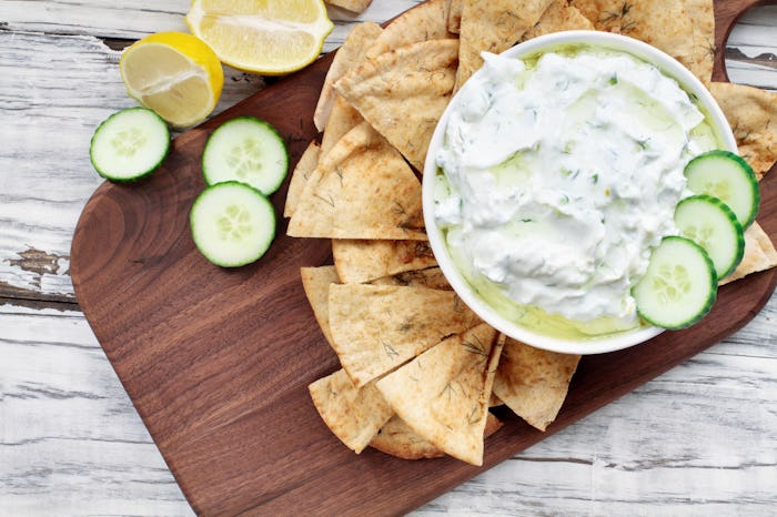 Traditional Greek Tzatziki dip sauce made with cucumber sour cream, Greek yogurt, lemon juice, olive...