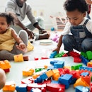 Diverse children enjoying playing with colorful toy blocks.