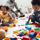 Diverse children enjoying playing with colorful toy blocks.