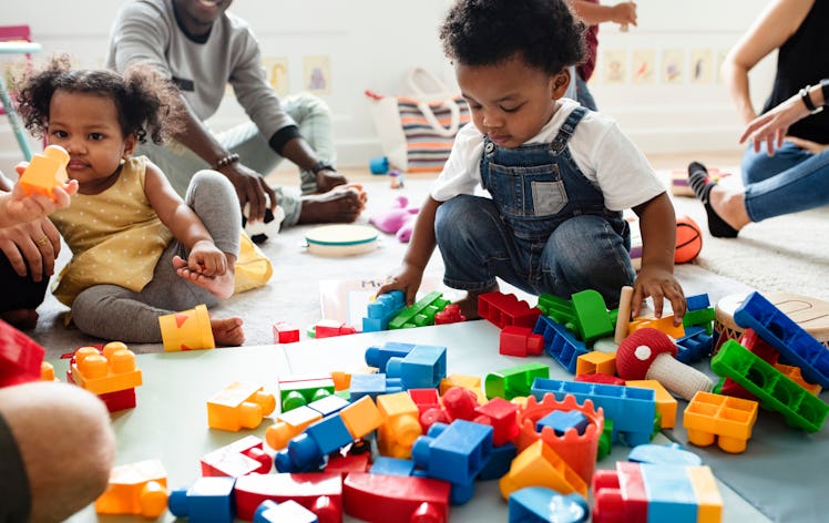 Diverse children enjoying playing with colorful toy blocks.