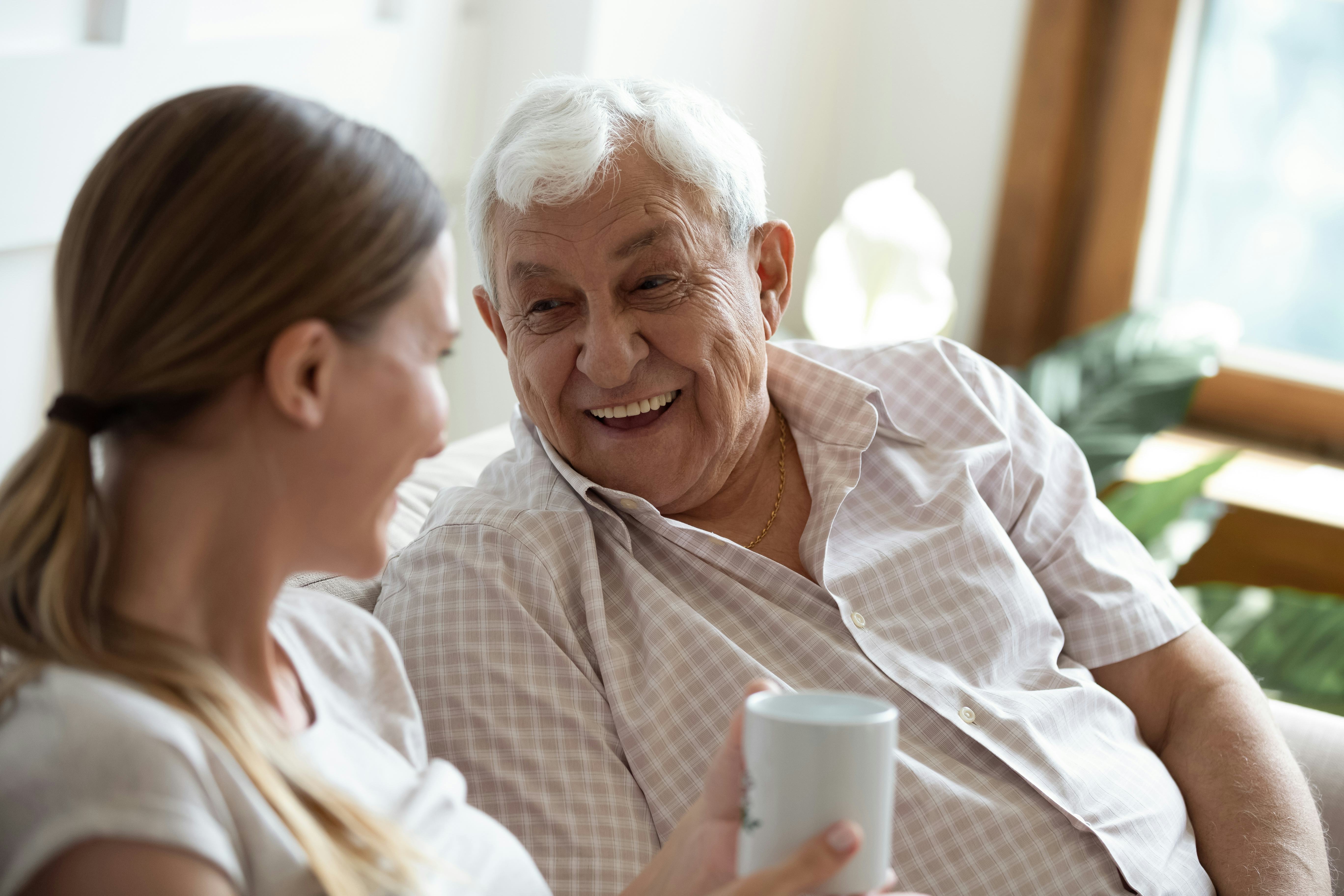 Head shot focus on happy old man talking with smiling grown up adult daughter, sitting together on s&hellip;