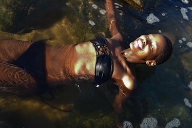  young beautiful black African female swimming at the beach