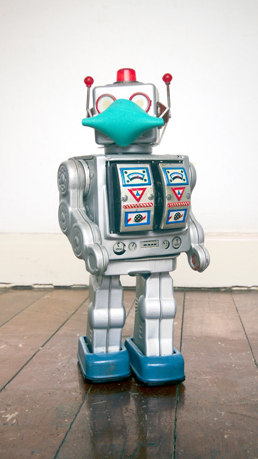 retro robot with text CIVID 19 on a old wooden floor