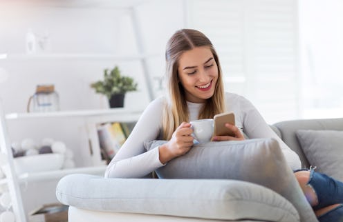 Young woman using her smartphone at home