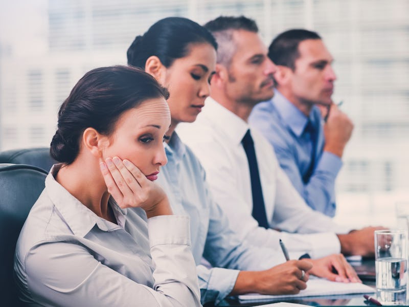 Businesswoman in bright office getting bored while attending presentation