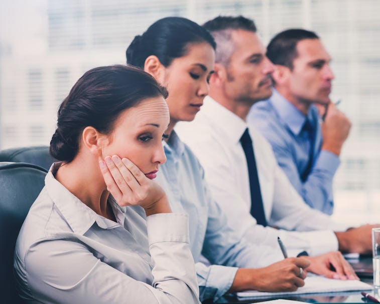 Businesswoman in bright office getting bored while attending presentation