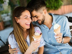 Happy couple having date and eating ice cream