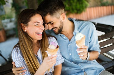 Happy couple having date and eating ice cream