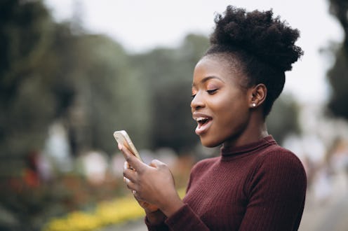 A woman is texting her crush and looking surprised. Valentine's Day 2022 and the Full Snow Moon will...