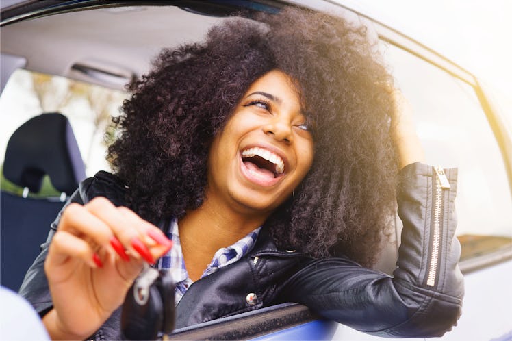big smile, afro hair girl with beautiful bright teeth. stylish black girl happy sitting in her car