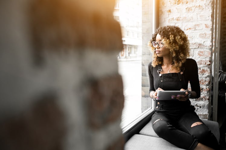 african american woman using laptop and phone