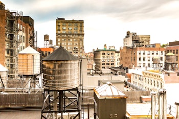 A view of old buildings and water towers in Midtown, Manhattan in New York City. 
