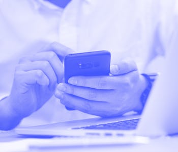 close up focus man hand hold mobile for work or play or check alert notification on smart phone devi...