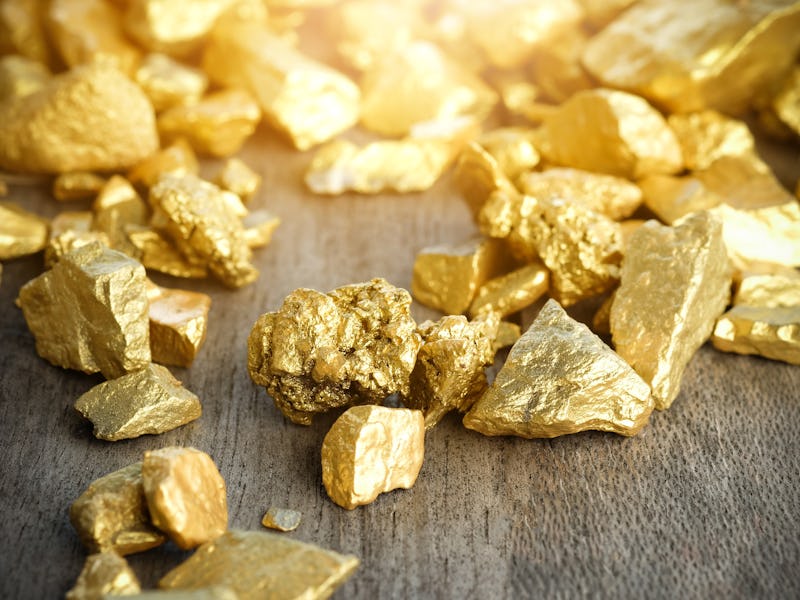 Close up lump of gold mine on wooden table