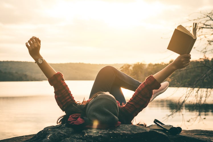 Women tourists read books in quiet nature.