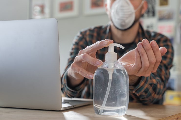 Coronavirus. Man working from home wearing protective mask. quarantine for coronavirus wearing prote...