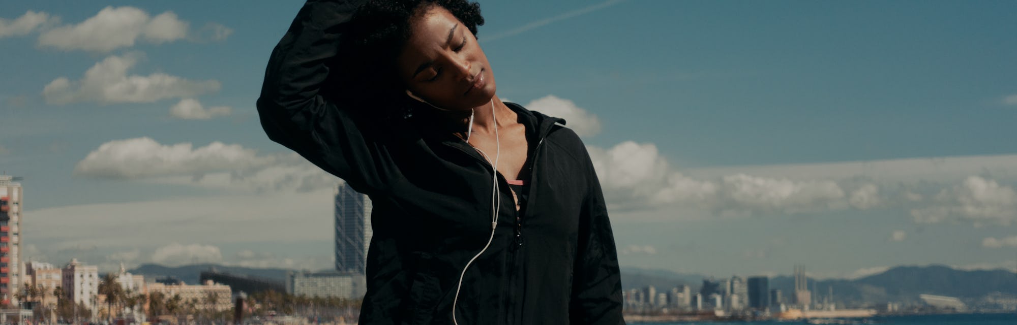 Young happy black woman doing workout outdoors