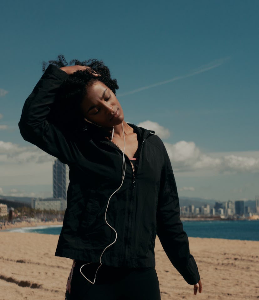 Young happy black woman doing workout outdoors