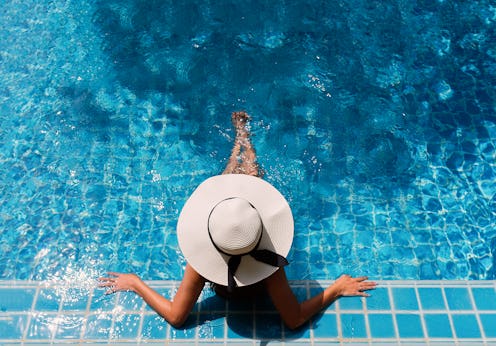 Young asian woman relaxing in swimming pool at spa resort.relaxing concept.