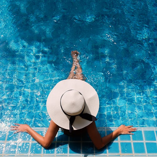 Young asian woman relaxing in swimming pool at spa resort.relaxing concept.