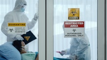 coronavirus covid 19 quarantine and breakout alert sign on window of quarantine room at hospital wit...