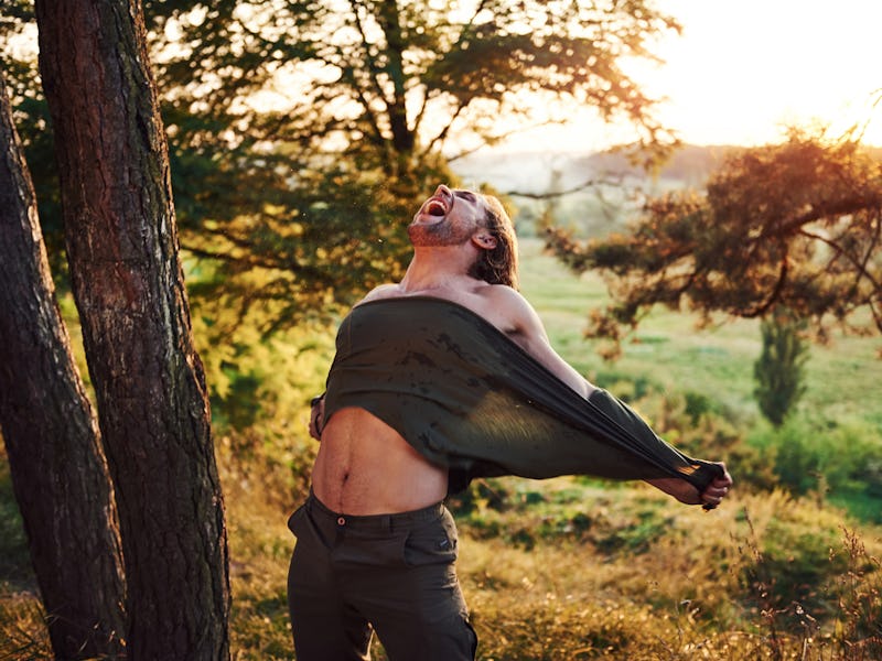Screaming and tearing the shirt. Conception of freedom. Beautiful man in the forest. Good weather. B...