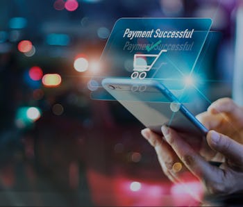 Woman using mobile smart phone, online payment, banking and online shopping in the night light color...