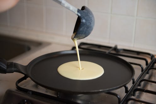 Making fresh homemade thin crepes pancakes