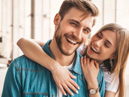 Portrait of smiling beautiful girl and her handsome boyfriend. Woman in casual summer jeans clothes....